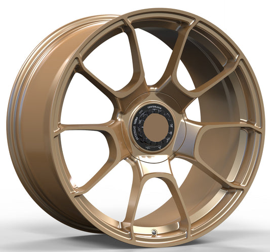 Gold alloy wheel with a prominent logo on a white background